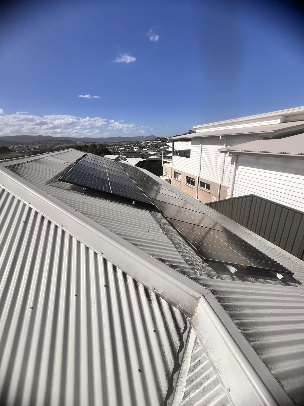 Steel bird mesh sealing the gap beneath rooftop solar panels on an Australian home