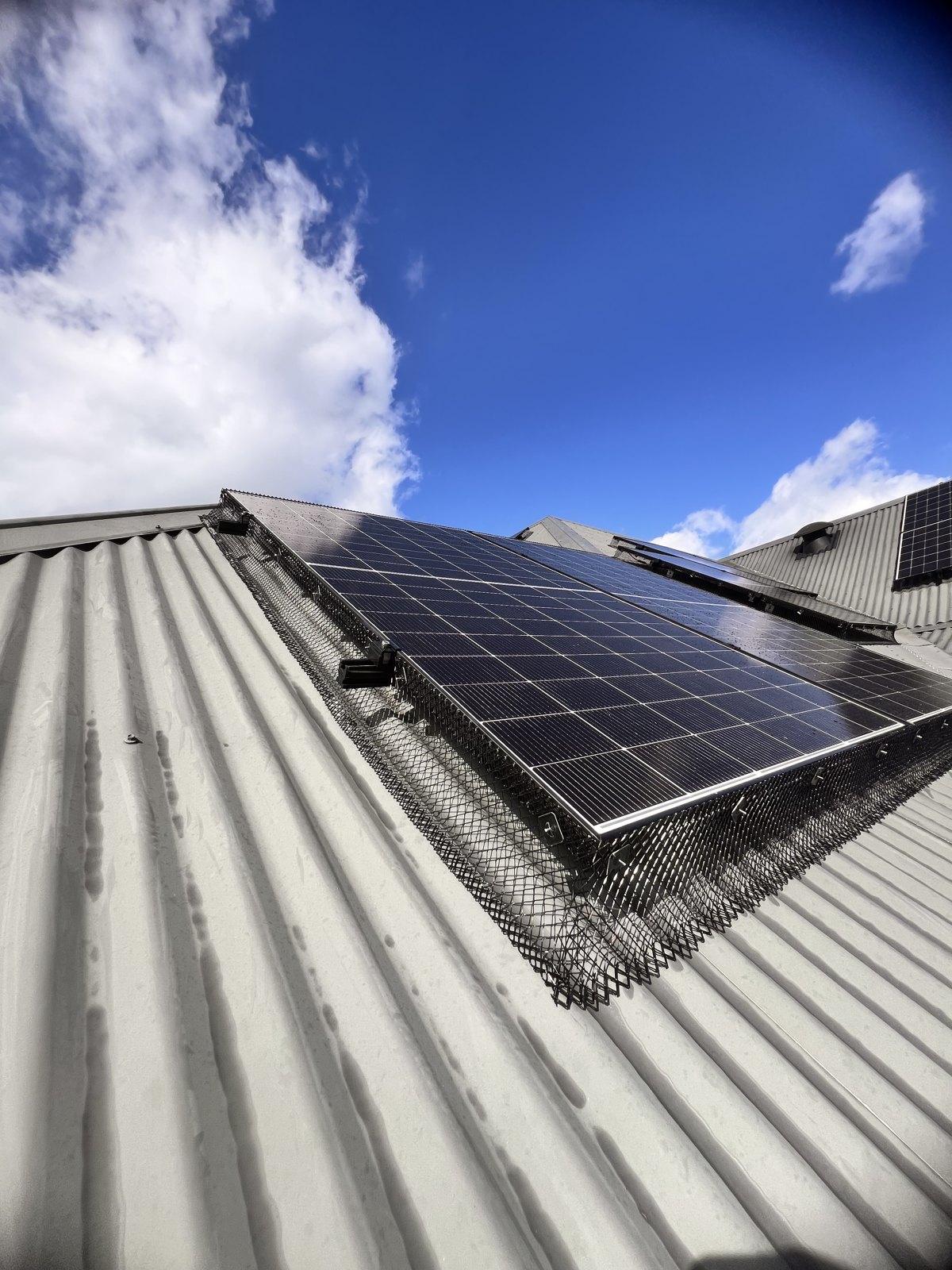 Solar panel bird proofing mesh professionally installed on an Australian roof